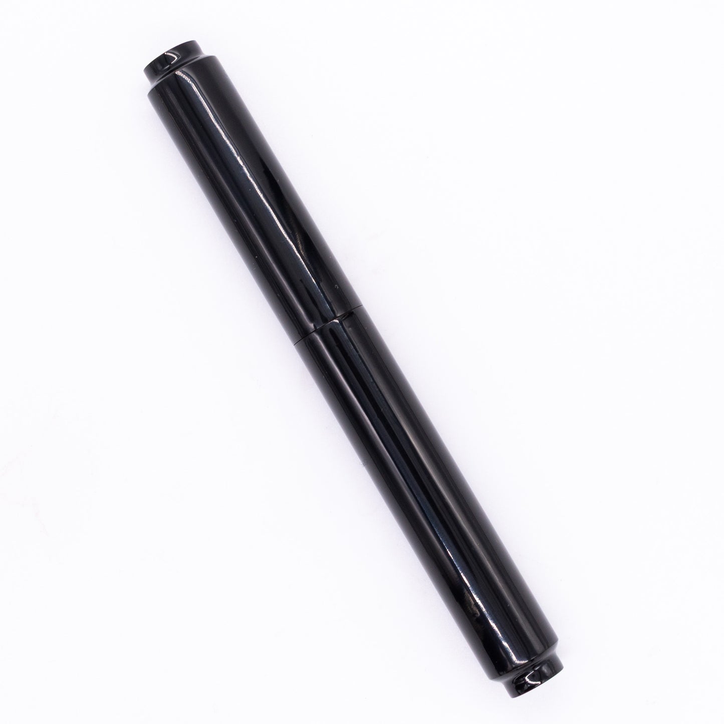An overhead view of the AP Limited Editions Urushi Lacquer Art Fountain Pen - Roiro Black capped, angled towards the left.