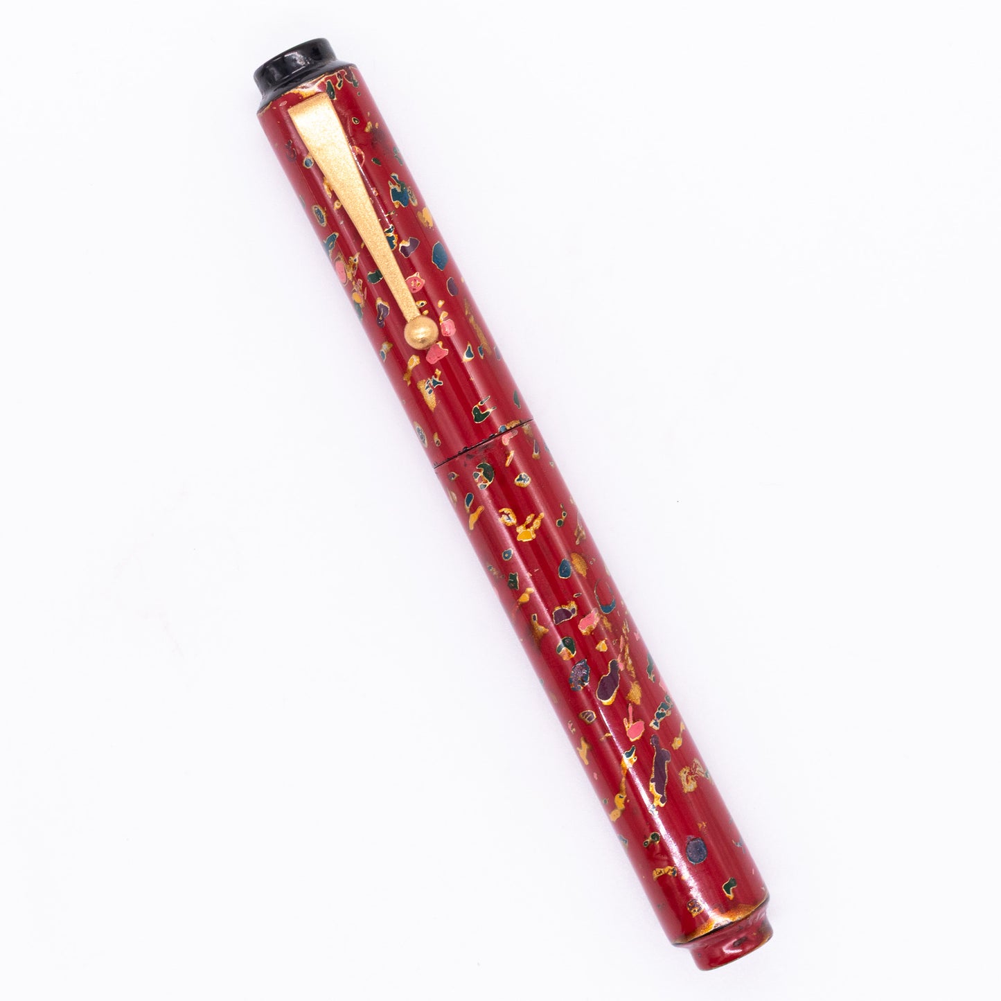 An overhead view of the AP Limited Editions Urushi Lacquer Art Fountain Pen - The Magical Urushi Red capped, angled towards the left.