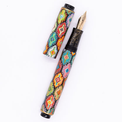 An overhead view of the AP Limited Editions Imperial Lacquer Art Fountain Pen - Tutankhamen uncapped, with the cap next to the body angled towards the right.