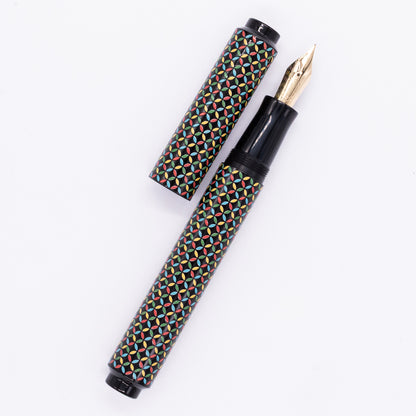 An overhead view of the AP Limited Editions Sakura Lacquer Art Fountain Pen - Rhythm uncapped, with the cap next to the body angled towards the right.