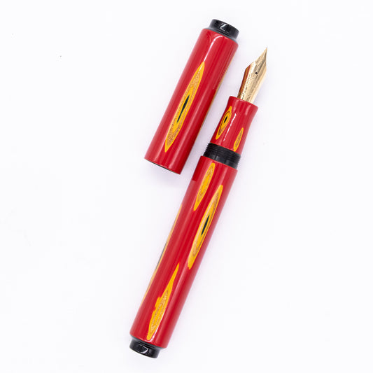 An overhead view of the AP Limited Editions Urushi Lacquer Art Fountain Pen - Amorphous Splendour Red uncapped, with the cap next to the body angled towards the right.