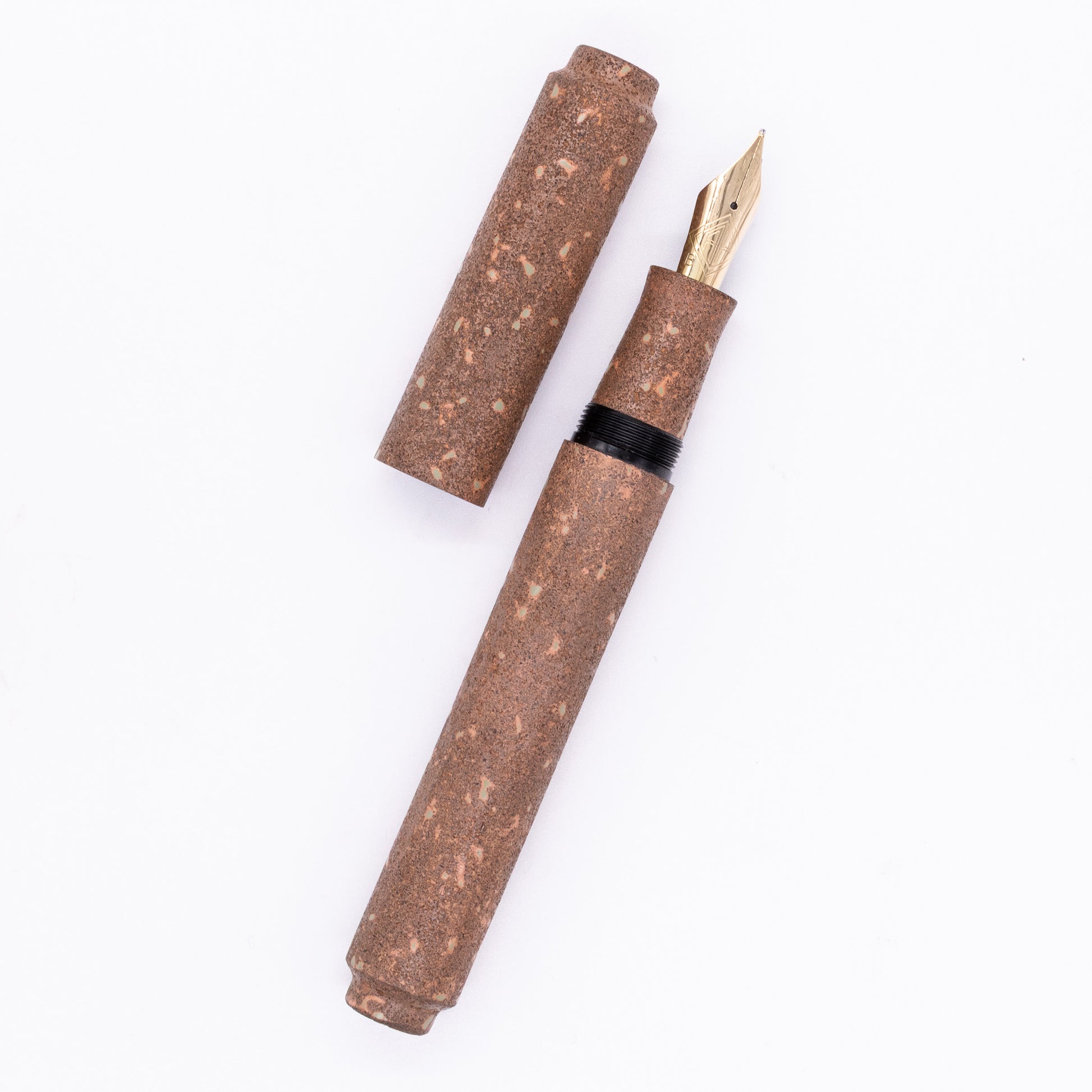 An overhead view of the AP Limited Editions Urushi Lacquer Art Fountain Pen - Biosignatures uncapped, with the cap next to the body angled towards the right.