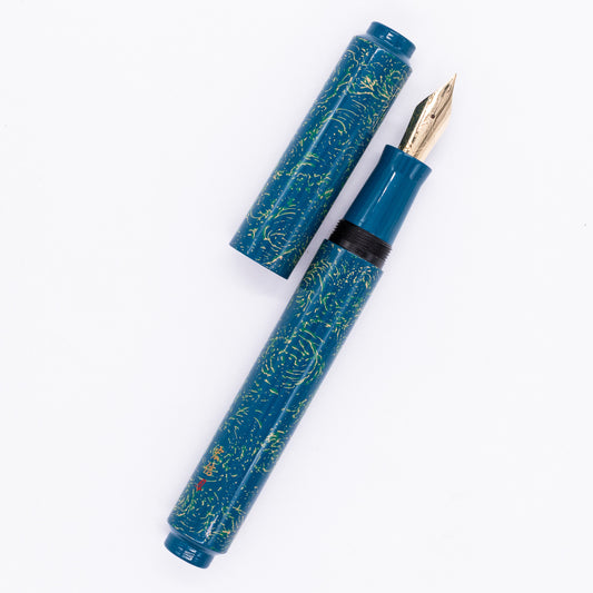  An overhead view of the AP Limited Editions Urushi Lacquer Art Fountain Pen - Blue Bliss uncapped, with the cap next to the body angled towards the right.