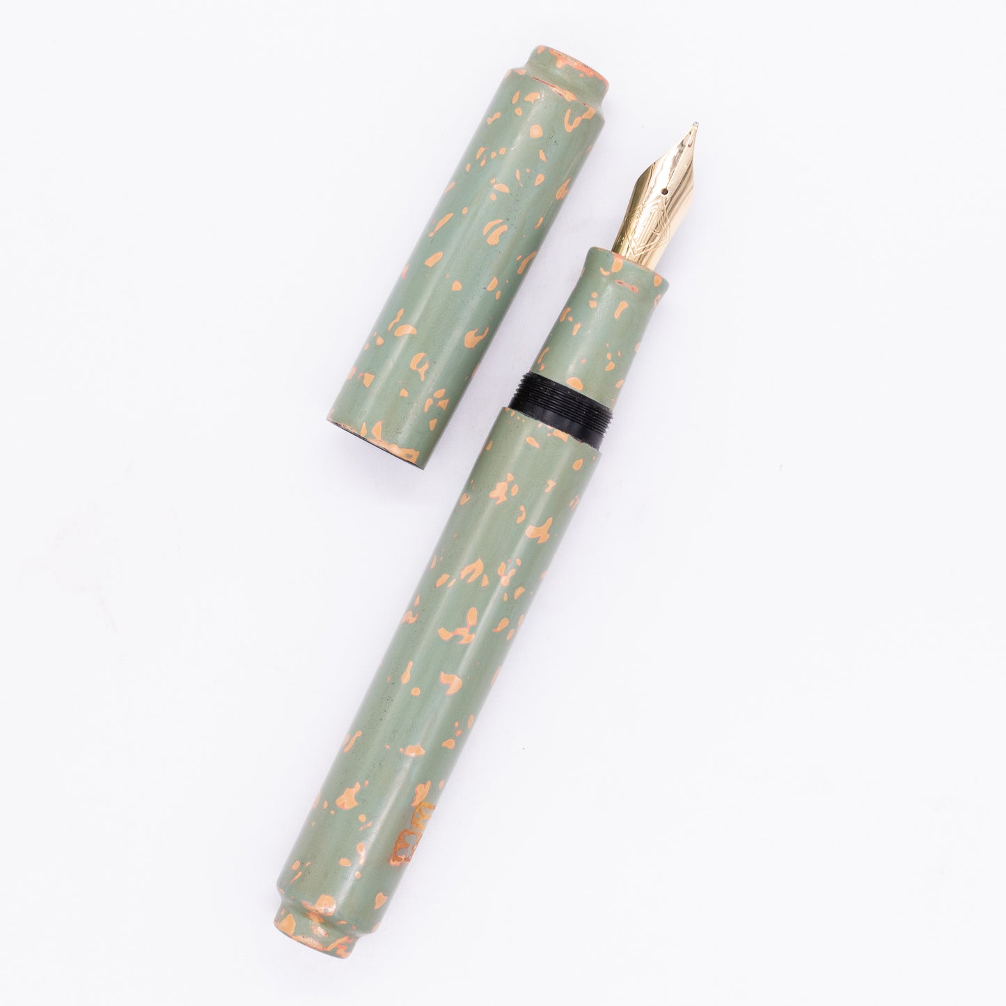 An overhead view of the AP Limited Editions Urushi Lacquer Art Fountain Pen - Garden Stone uncapped, with the cap next to the body angled towards the right.