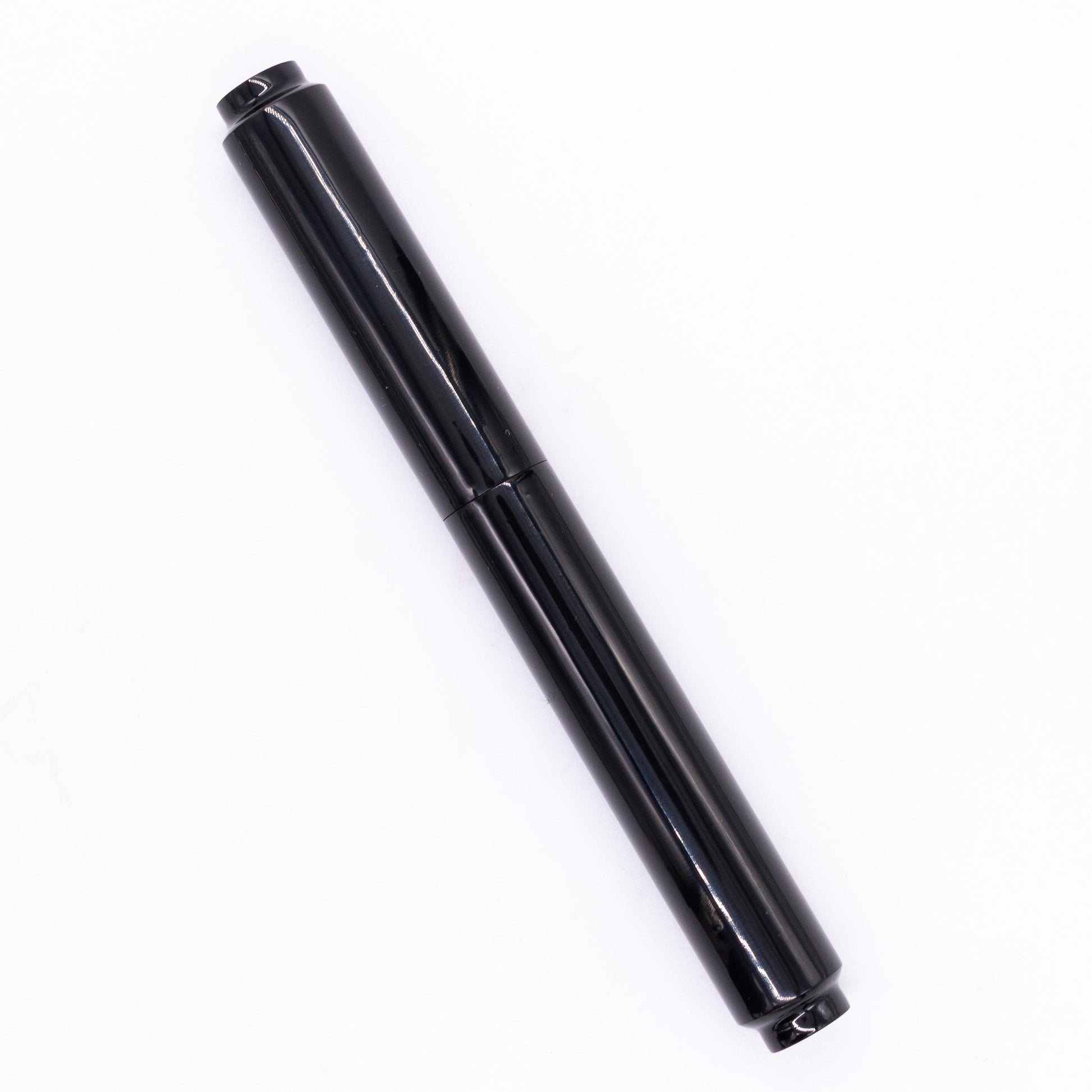An overhead view of the AP Limited Editions Urushi Lacquer Art Fountain Pen - Roiro Black capped, angled towards the left.