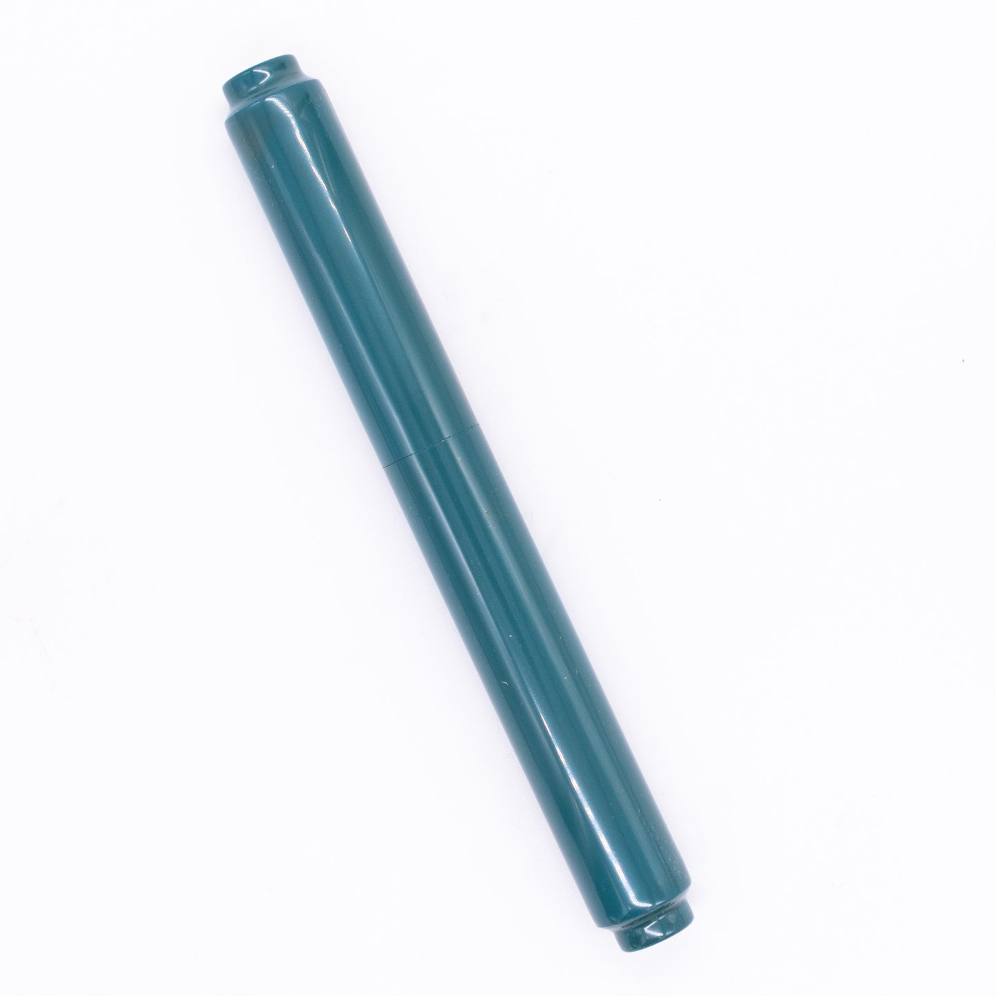 An overhead view of the AP Limited Editions Urushi Lacquer Art Fountain Pen - Seiheki Green capped, angled towards the left.