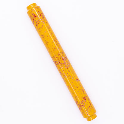 An overhead view of the AP Limited Editions Urushi Lacquer Art Fountain Pen - Sunshine capped, angled towards the left.