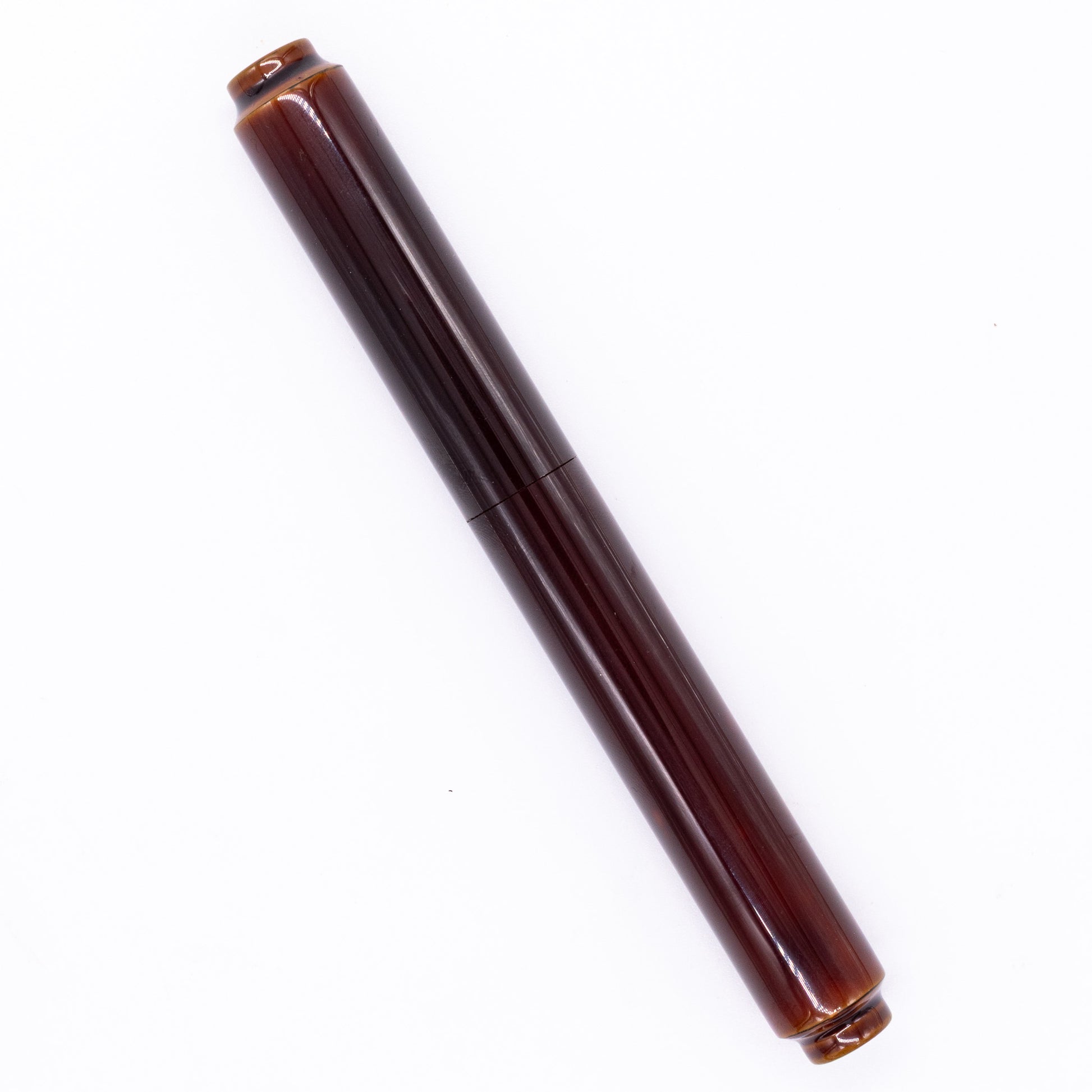 An overhead view of the AP Limited Editions Urushi Lacquer Art Fountain Pen - Tamenuri Yellow capped, angled towards the left.