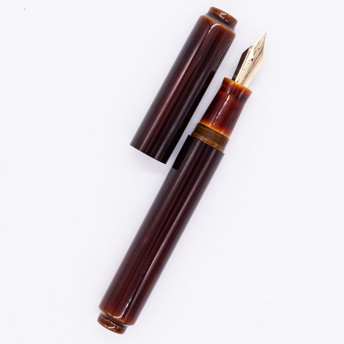  An overhead view of the AP Limited Editions Urushi Lacquer Art Fountain Pen - Tamenuri Yellow uncapped, with the cap next to the body angled towards the right.