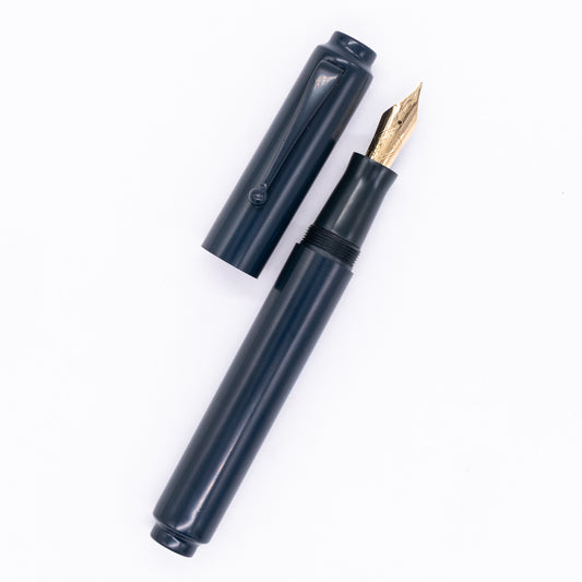 An overhead view of the AP Limited Editions Urushi Lacquer Art Fountain Pen - Tetsu Kon uncapped, with the cap next to the body angled towards the right.
