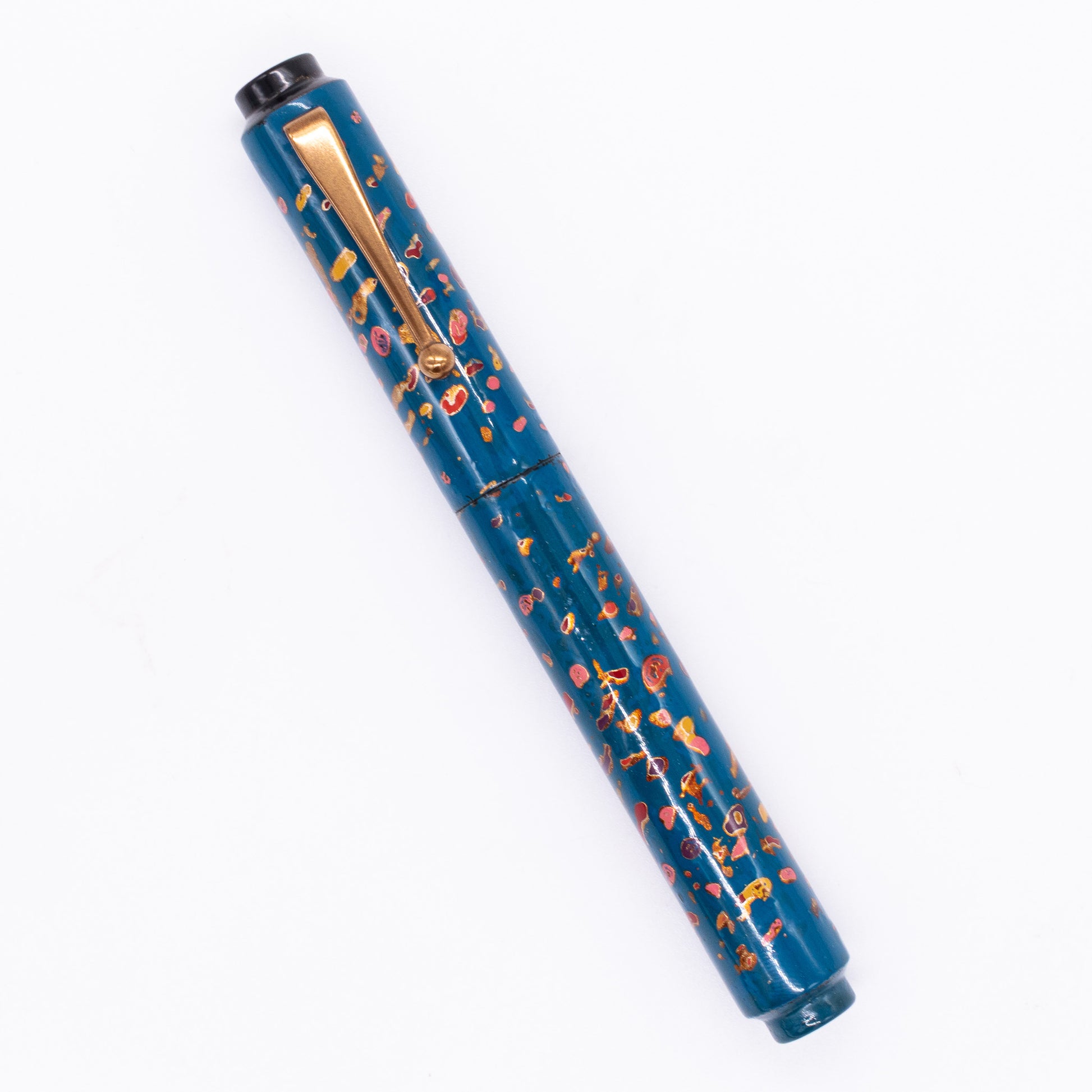 An overhead view of the AP Limited Editions Urushi Lacquer Art Fountain Pen - The Magical Urushi Blue capped, angled towards the left.