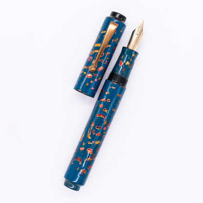 An overhead view of the AP Limited Editions Urushi Lacquer Art Fountain Pen - The Magical Urushi Blue uncapped, with the cap next to the body angled towards the right.