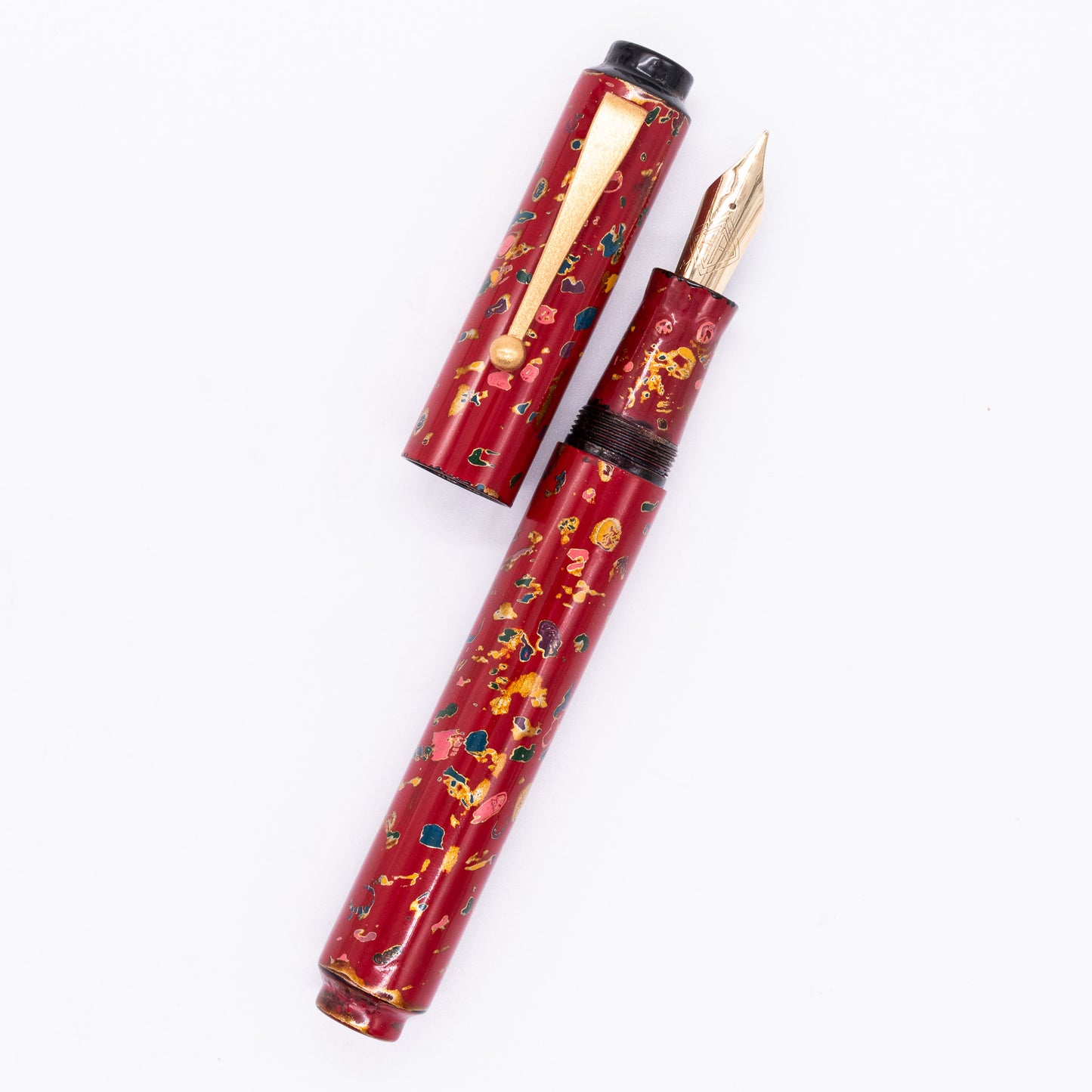 An overhead view of the AP Limited Editions Urushi Lacquer Art Fountain Pen - The Magical Urushi Red uncapped, with the cap next to the body angled towards the right.