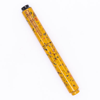 An overhead view of the AP Limited Editions Urushi Lacquer Art Fountain Pen - The Magical Urushi Yellow (with Bamboo Clip) capped, angled towards the left.