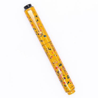 An overhead view of the AP Limited Editions Urushi Lacquer Art Fountain Pen - The Magical Urushi Yellow capped, angled towards the left.
