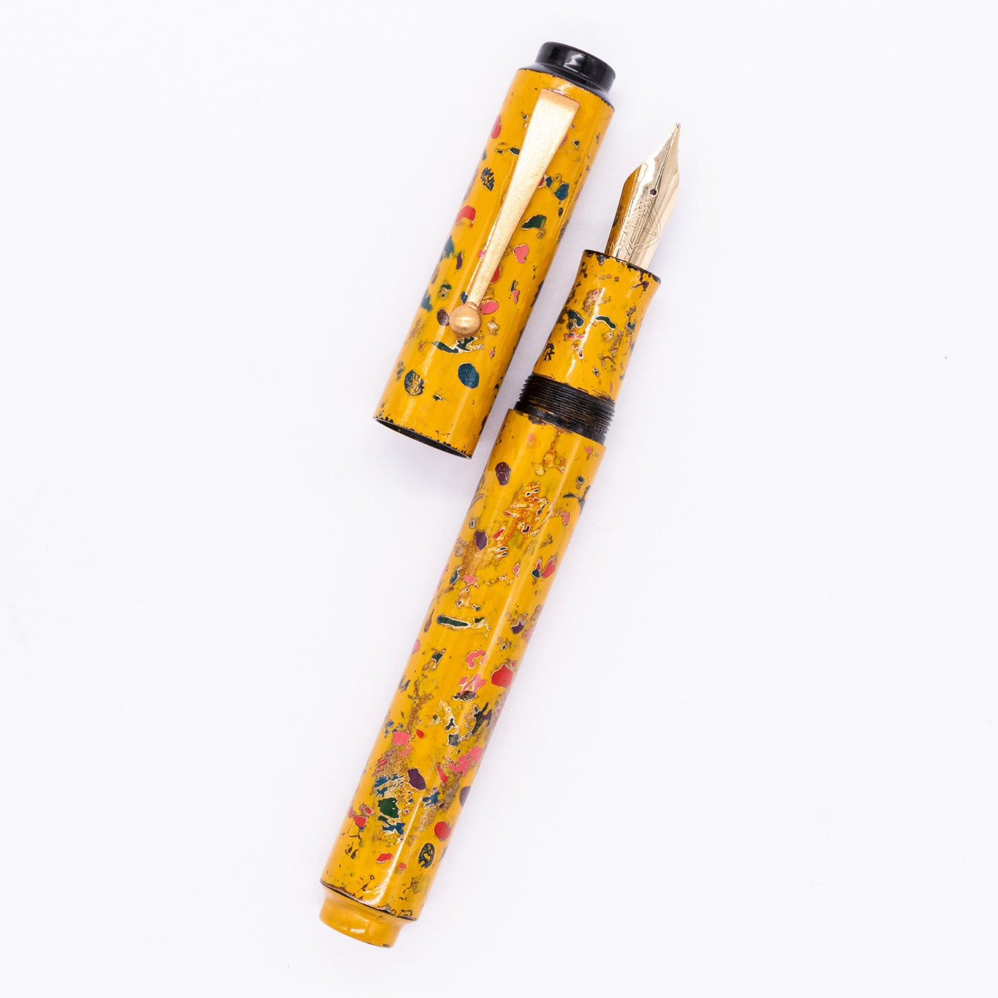 An overhead view of the AP Limited Editions Urushi Lacquer Art Fountain Pen - The Magical Urushi Yellow uncapped, with the cap next to the body angled towards the right.