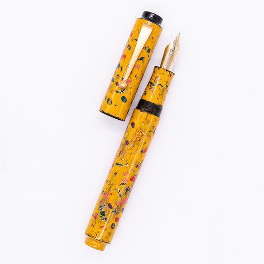 An overhead view of the AP Limited Editions Urushi Lacquer Art Fountain Pen - The Magical Urushi Yellow uncapped, with the cap next to the body angled towards the right.