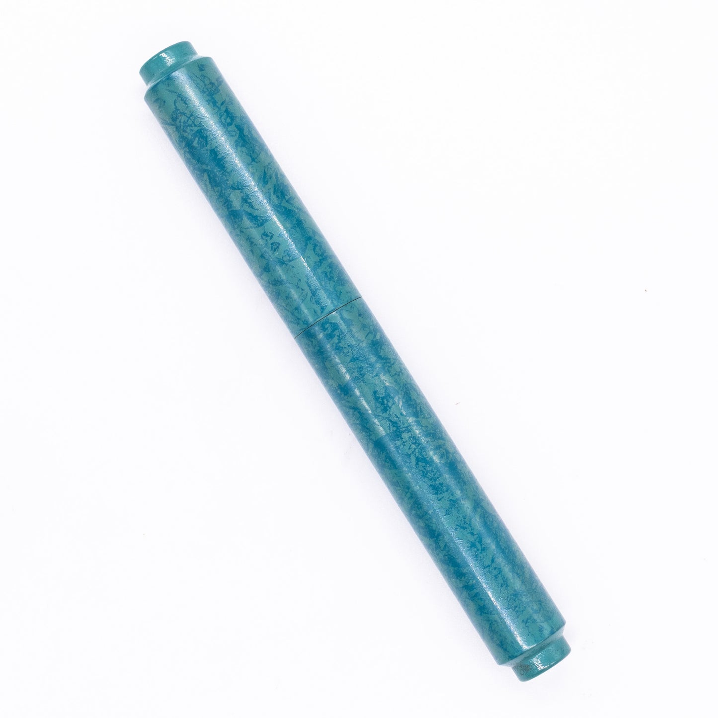 An overhead view of the AP Limited Editions Urushi Lacquer Art Fountain Pen - Tidal Stone capped, angled towards the left.