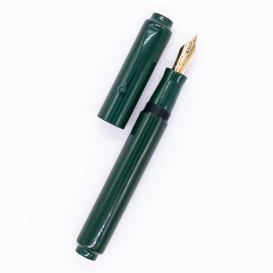 An overhead view of the AP Limited Editions Urushi Lacquer Art Fountain Pen - Tokiwa Midori uncapped, with the cap next to the body angled towards the right.