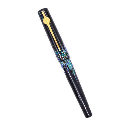 An overhead view of the ConCoPens Traditional Vietnamese Lacquer Fountain Pen - Aurora 2 capped, angled towards the left.