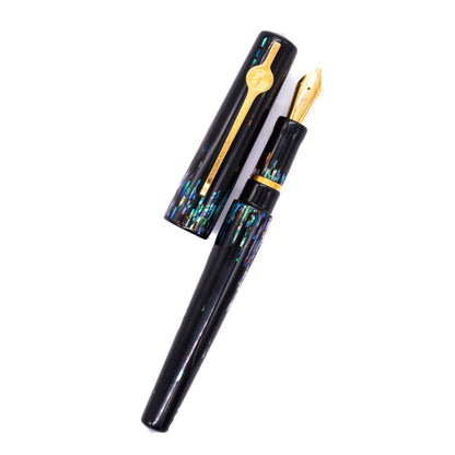  An overhead view of the ConCoPens Traditional Vietnamese Lacquer Fountain Pen - Aurora 2 uncapped, with the cap next to the body angled towards the right.
