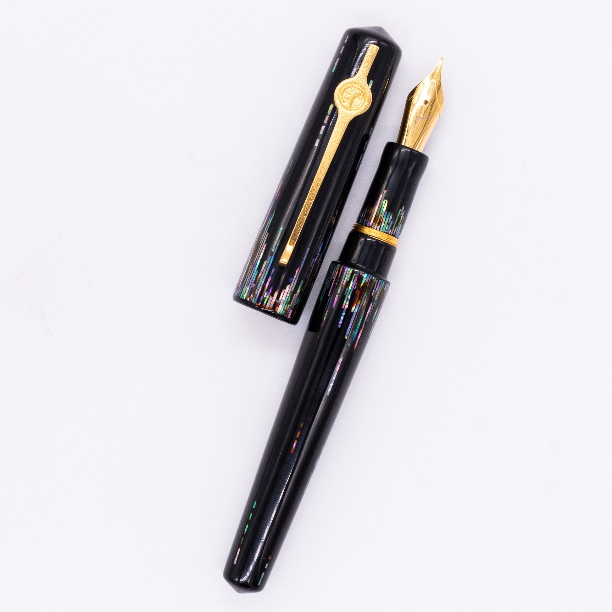An overhead view of the ConCoPens Traditional Vietnamese Lacquer Fountain Pen - Aurora uncapped, with the cap next to the body angled towards the right.