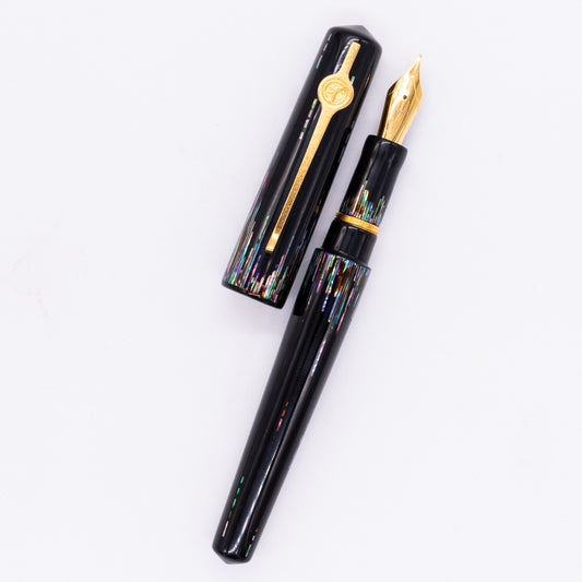 An overhead view of the ConCoPens Traditional Vietnamese Lacquer Fountain Pen - Aurora uncapped, with the cap next to the body angled towards the right.