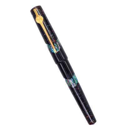 An overhead view of the ConCoPens Traditional Vietnamese Lacquer Fountain Pen - Ocean Serenade 2 capped, angled towards the left.