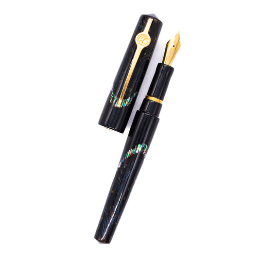 An overhead view of the ConCoPens Traditional Vietnamese Lacquer Fountain Pen - Ocean Serenade uncapped, with the cap next to the body angled towards the right.