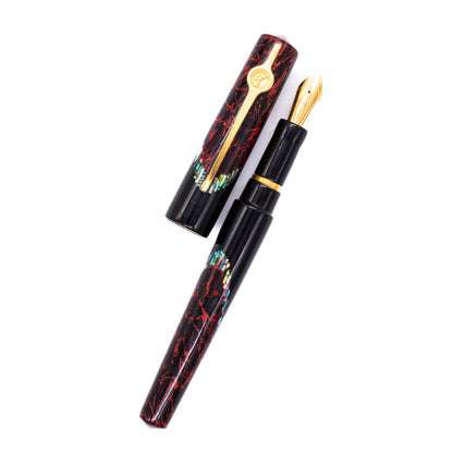 An overhead view of the ConCoPens Traditional Vietnamese Lacquer Fountain Pen - Pyre uncapped, with the cap next to the body angled towards the right.